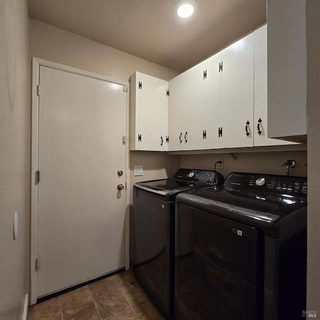 clothes washing area with cabinet space and washer and dryer