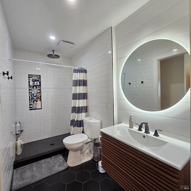 full bathroom featuring vanity, a tile shower, tile walls, toilet, and tile patterned floors