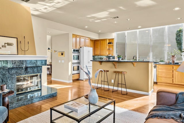 2909 Quail Hollow Dr, Fairfield, CA 94534 - living area with light wood-type flooring, visible vents, recessed lighting, baseboards, and a tile fireplace