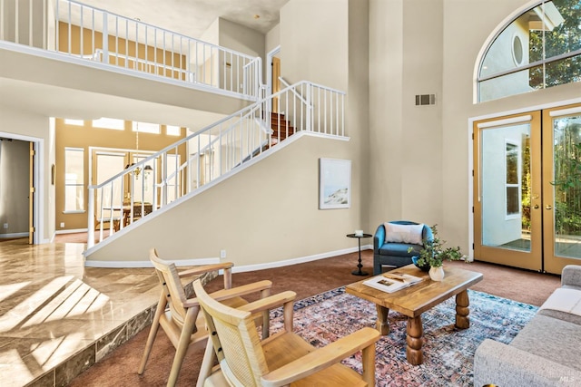 2909 Quail Hollow Dr, Fairfield, CA 94534 - living room featuring french doors, a towering ceiling, visible vents, stairway, and baseboards