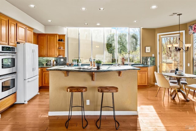 2909 Quail Hollow Dr, Fairfield, CA 94534 - kitchen with freestanding refrigerator, light wood finished floors, stainless steel double oven, open shelves, and a kitchen island