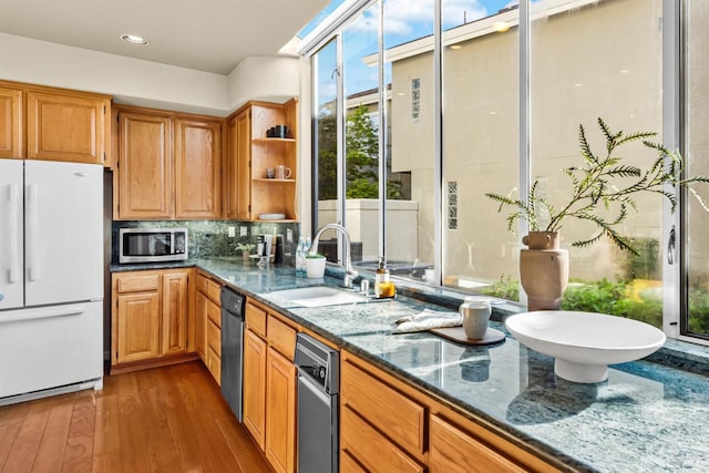 2909 Quail Hollow Dr, Fairfield, CA 94534 - kitchen with wood finished floors, a sink, dark stone counters, open shelves, and stainless steel appliances