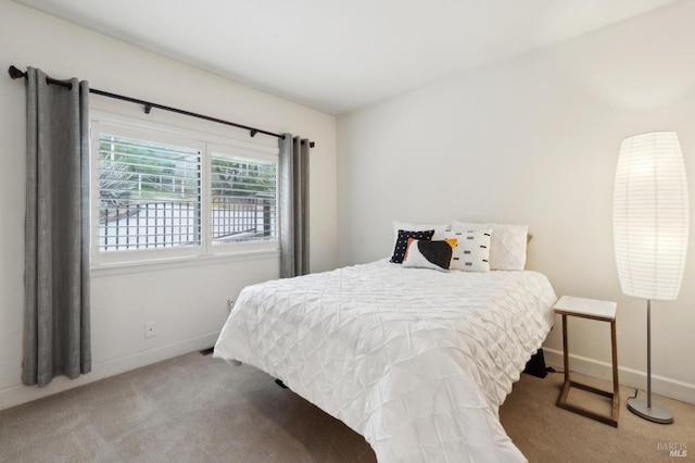 carpeted bedroom with baseboards