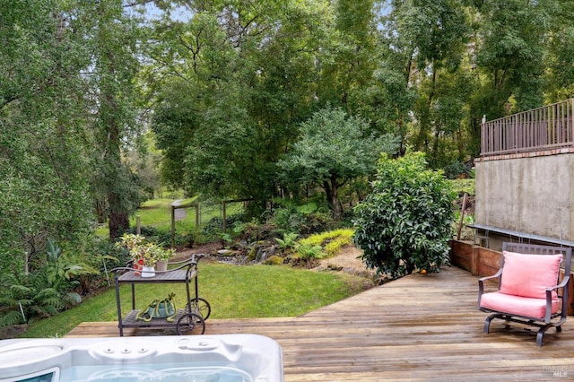 deck with hot tub deck surround and a yard