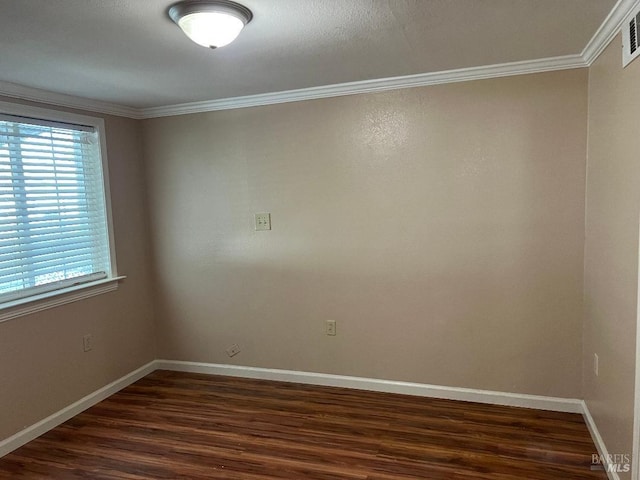 unfurnished room featuring baseboards, visible vents, crown molding, and dark wood-type flooring
