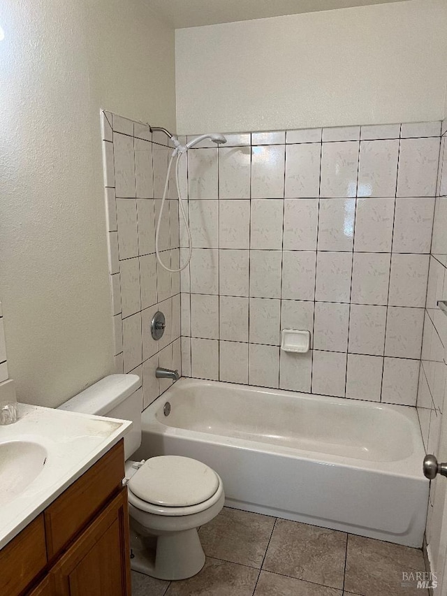 full bath featuring tile patterned flooring, vanity, toilet, and  shower combination