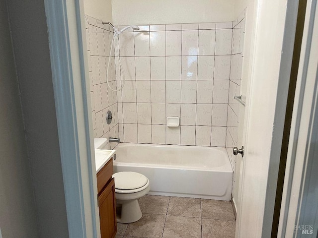 full bath featuring washtub / shower combination, tile patterned floors, toilet, and vanity