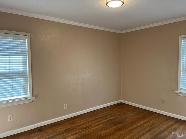 unfurnished room with dark wood finished floors, baseboards, and crown molding