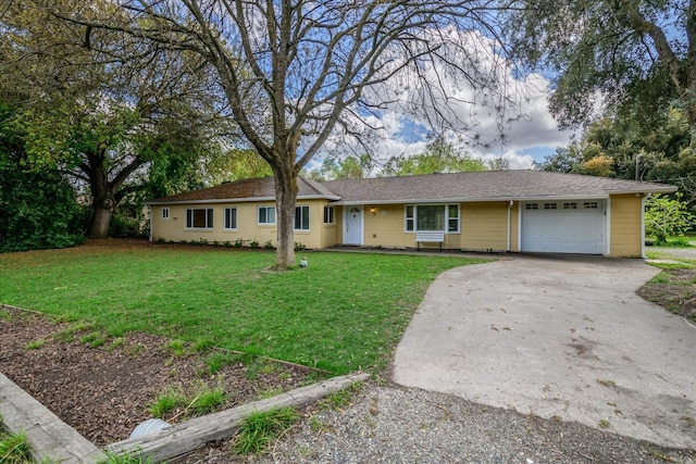 single story home with driveway, an attached garage, and a front lawn