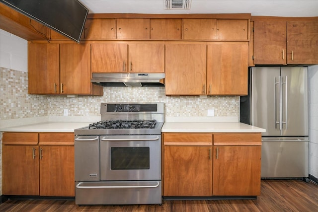 kitchen with light countertops, dark wood-style floors, stainless steel appliances, and under cabinet range hood