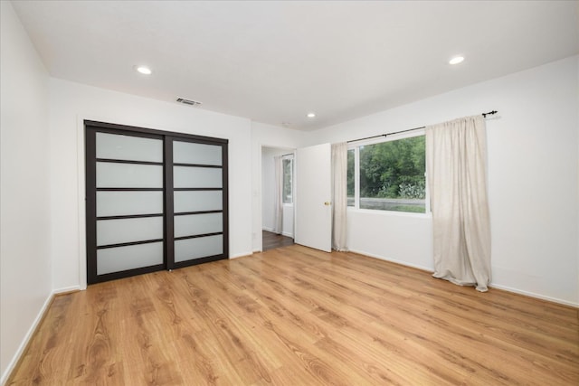 spare room featuring visible vents, light wood-type flooring, and recessed lighting