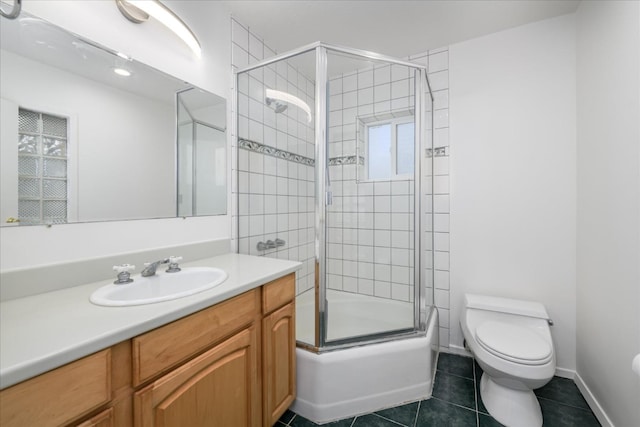 bathroom with tile patterned flooring, vanity, baseboards, and toilet