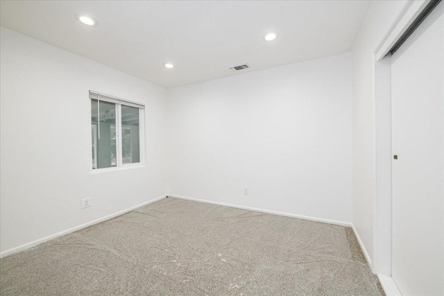 spare room with visible vents, baseboards, recessed lighting, and carpet floors