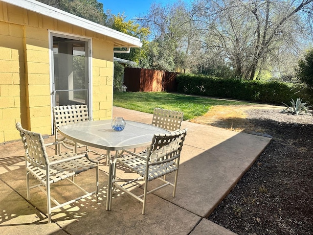 view of patio with fence and outdoor dining area