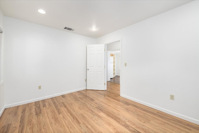 spare room with visible vents, baseboards, light wood finished floors, and recessed lighting
