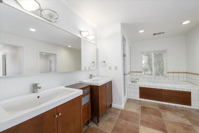 bathroom featuring a garden tub, a sink, visible vents, and recessed lighting