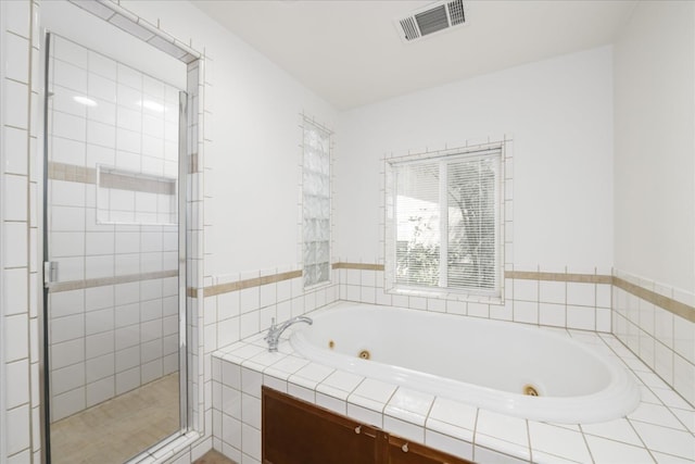 full bath featuring a jetted tub, visible vents, and a stall shower