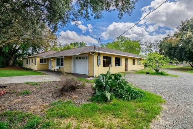 ranch-style house with an attached garage, concrete driveway, and concrete block siding