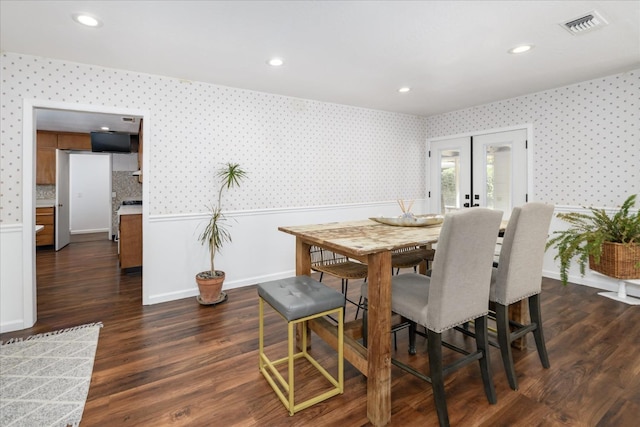 dining room with dark wood-type flooring, french doors, visible vents, and wallpapered walls