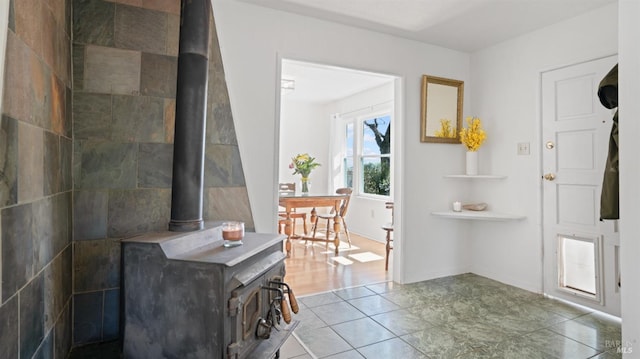 tiled foyer with a wood stove