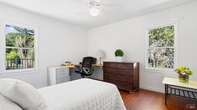 bedroom with baseboards, ceiling fan, and hardwood / wood-style floors