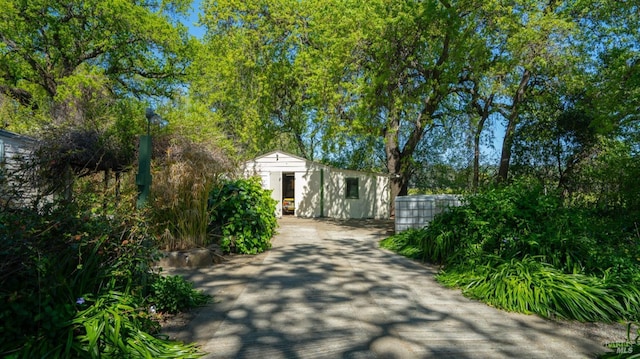 exterior space featuring an outdoor structure and driveway