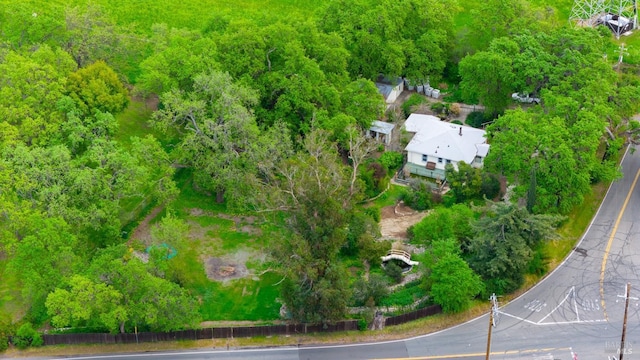 bird's eye view with a wooded view