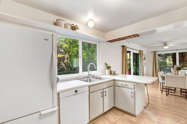 361 Neva St, Sebastopol, CA 95472 - kitchen with light countertops, a peninsula, white appliances, a sink, and light tile patterned floors