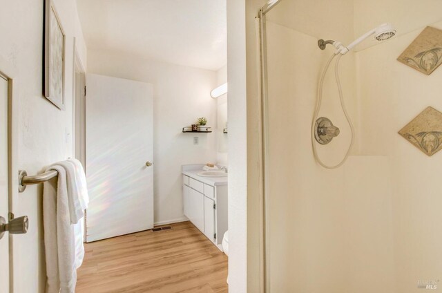 361 Neva St, Sebastopol, CA 95472 - bathroom featuring visible vents, wood finished floors, a shower, and vanity