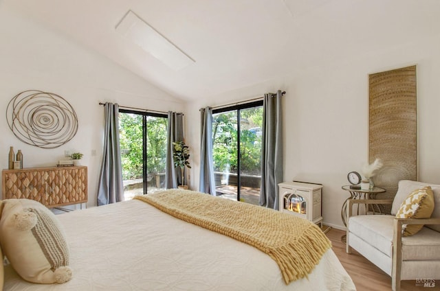 361 Neva St, Sebastopol, CA 95472 - bedroom featuring access to exterior, wood finished floors, a wood stove, and lofted ceiling with skylight