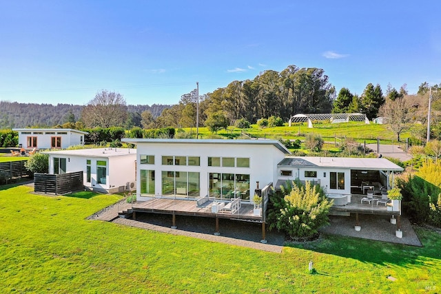 505 Dusty Ln, Sebastopol, CA 95472 - rear view of property with a yard, stucco siding, view of wooded area, and a wooden deck