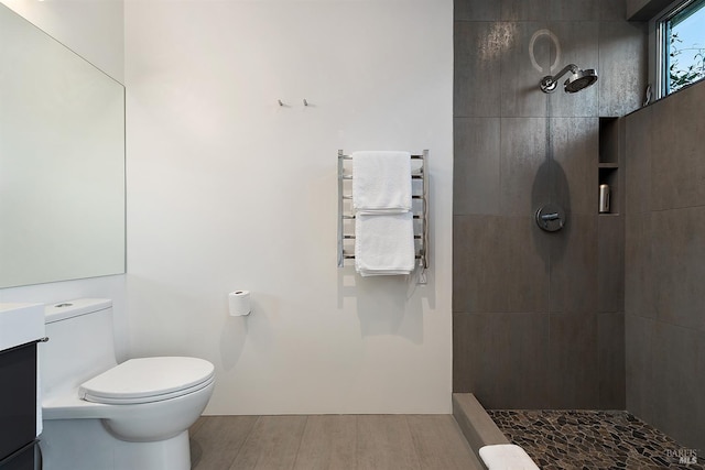 505 Dusty Ln, Sebastopol, CA 95472 - bathroom with radiator, tiled shower, a towel warming rack, wood finished floors, and vanity