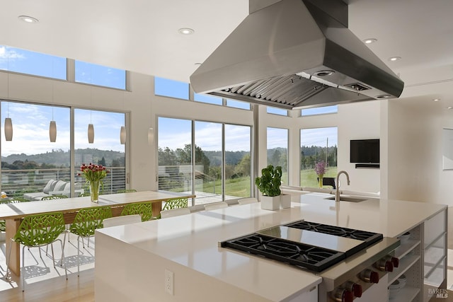 505 Dusty Ln, Sebastopol, CA 95472 - kitchen with a sink, stainless steel gas stovetop, island exhaust hood, and a healthy amount of sunlight
