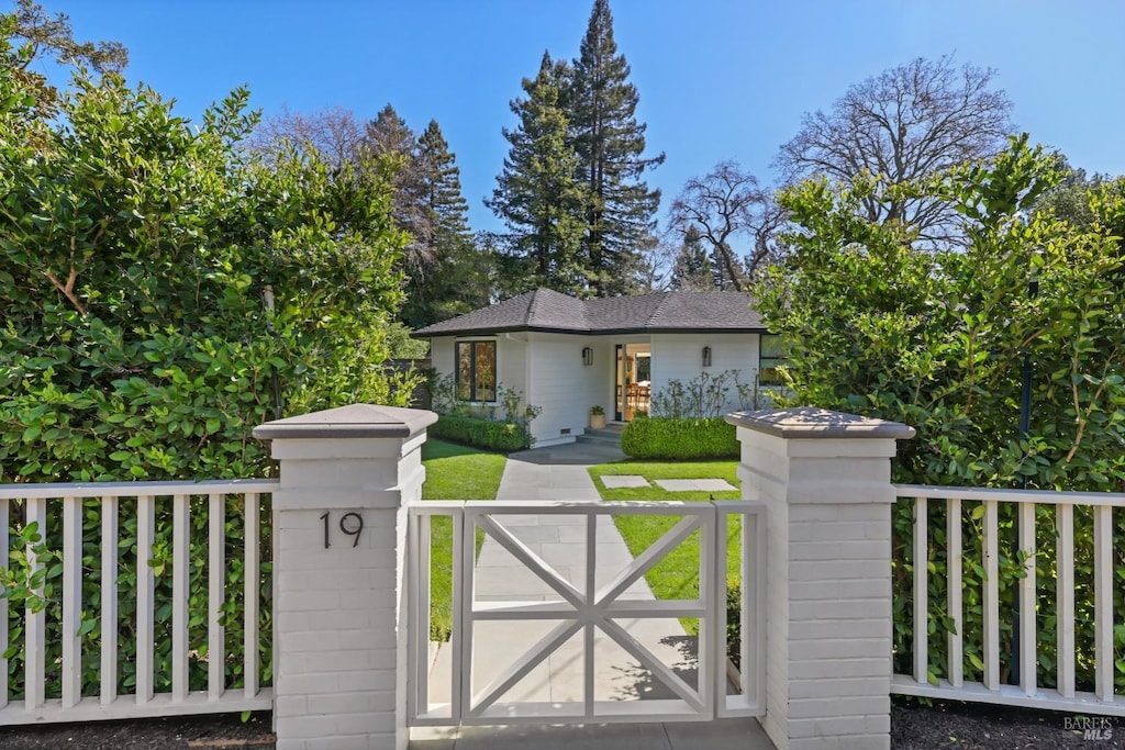 view of gate with a fenced front yard