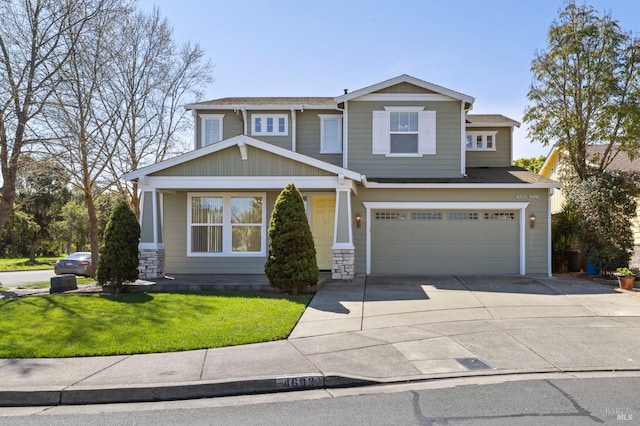 craftsman-style home with concrete driveway, a front lawn, roof with shingles, and an attached garage
