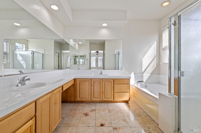 full bathroom featuring a stall shower, double vanity, a bath, and a sink