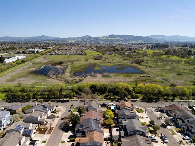 drone / aerial view featuring a residential view and a water and mountain view