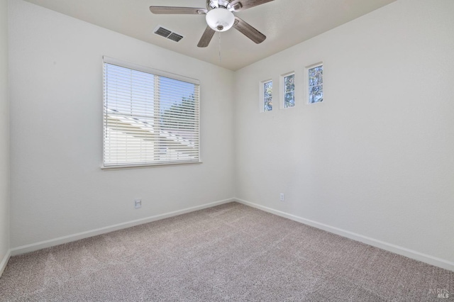 empty room featuring baseboards, carpet floors, ceiling fan, and visible vents