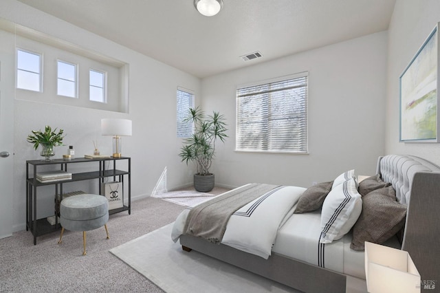 carpeted bedroom with baseboards and visible vents