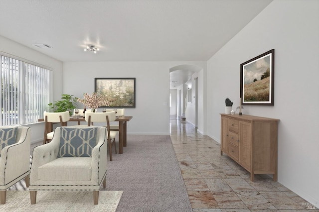 interior space featuring arched walkways, baseboards, and visible vents