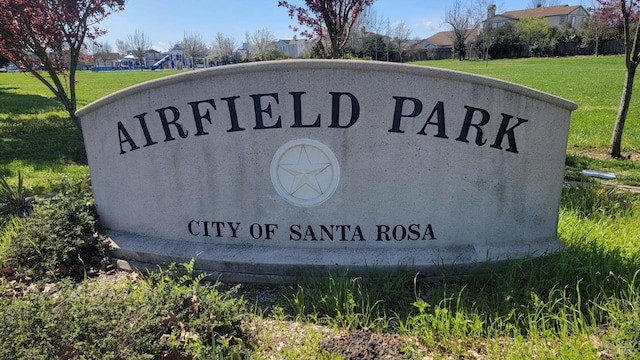 community sign featuring a lawn