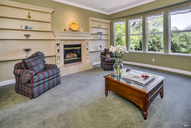living area featuring baseboards, a fireplace, carpet floors, and ornamental molding