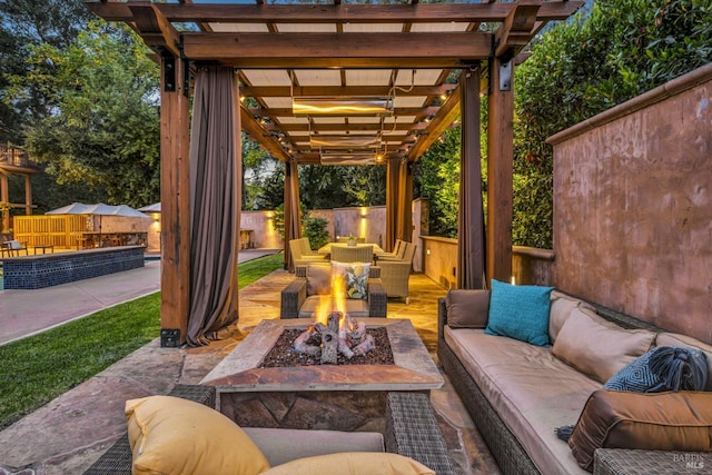 view of patio with an outdoor living space with a fire pit and a pergola