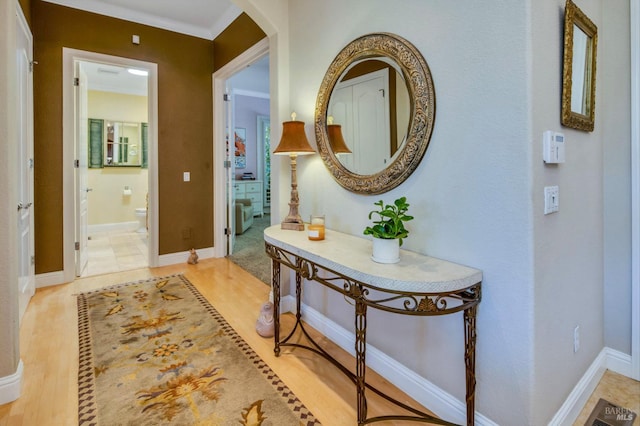 hall featuring baseboards and light wood-style flooring