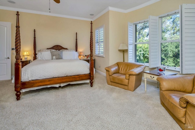 bedroom featuring baseboards, crown molding, carpet, and a ceiling fan