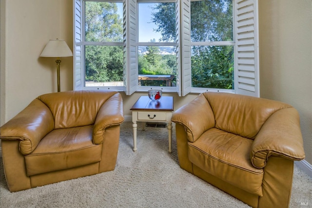 living room with baseboards, visible vents, and carpet flooring