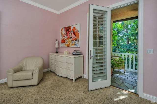 living area with baseboards and crown molding