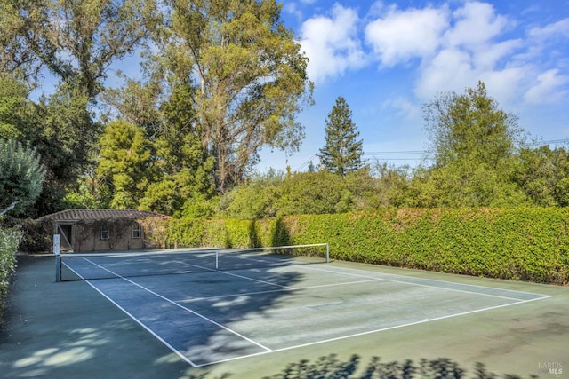 view of tennis court featuring community basketball court