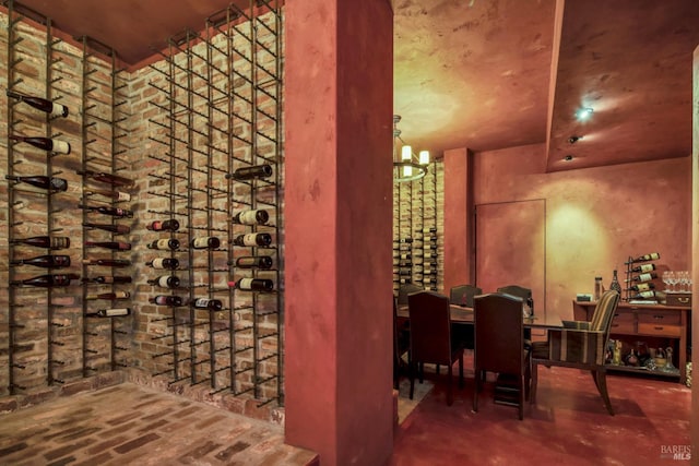 wine area with brick floor and a chandelier