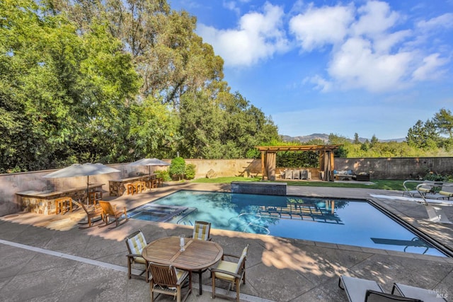 view of pool featuring fence, a fireplace, a fenced in pool, an in ground hot tub, and a patio area